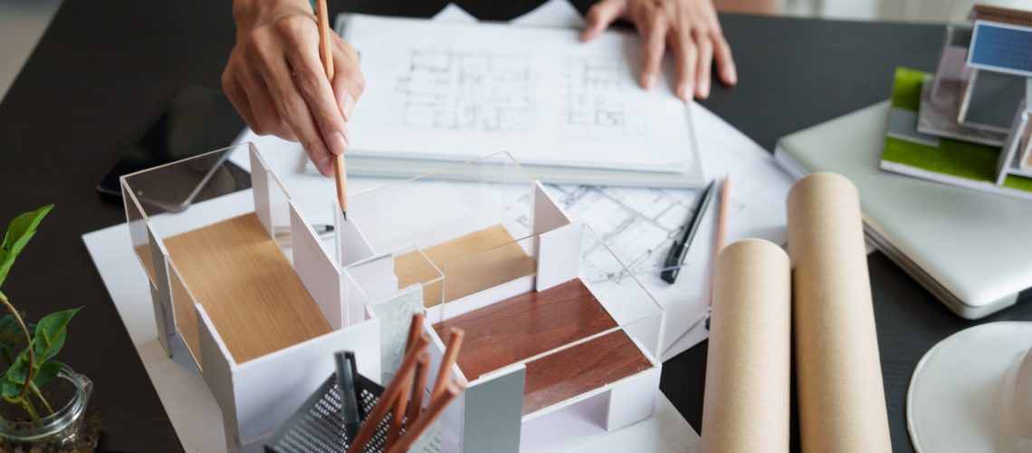 Architecture Man drawing on architectural Creative project business architecture building construction Industrial engineering Achievement Planning Design on eco blueprint